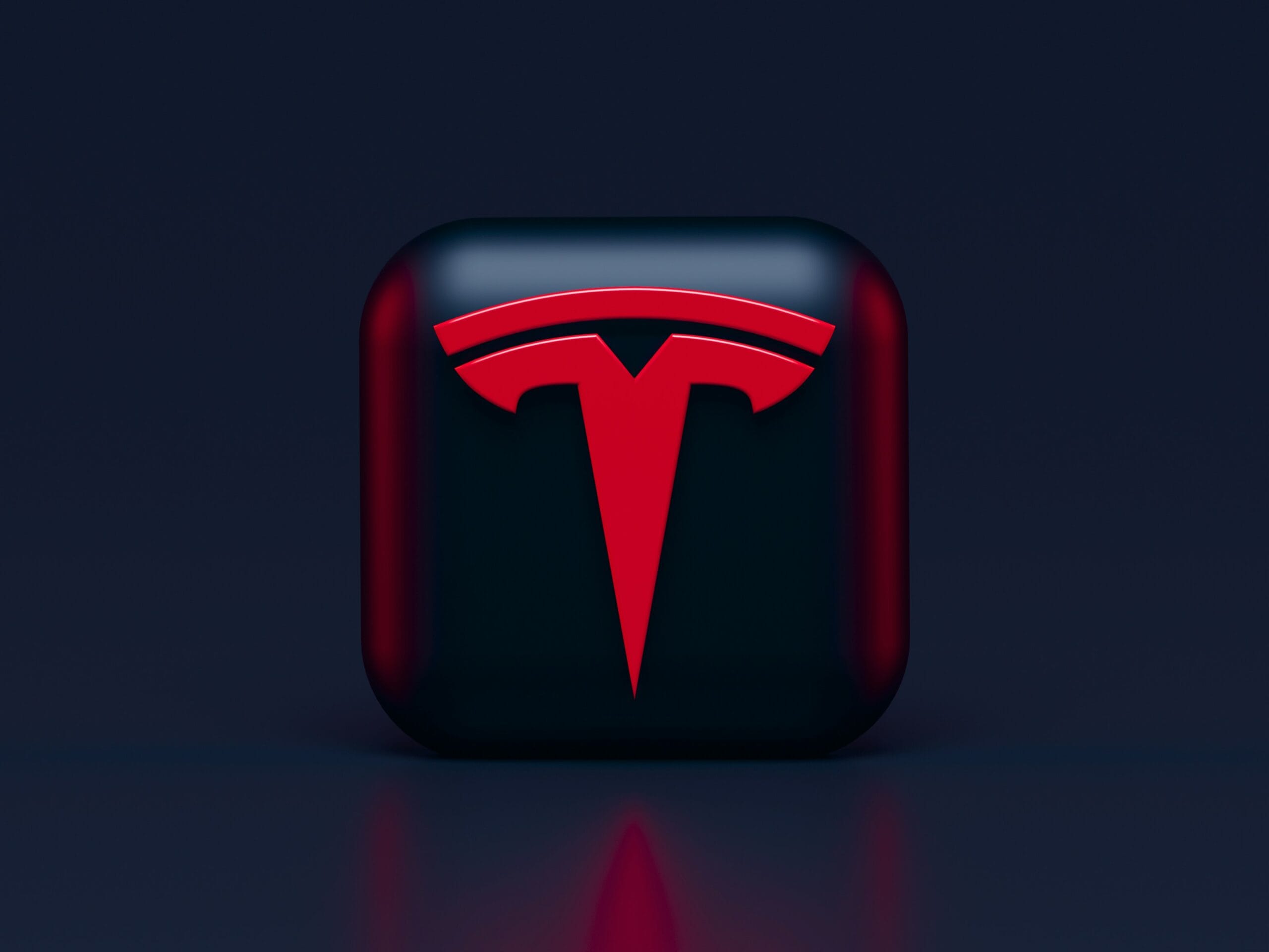 Tesla-logo i 3D med rød baggrund