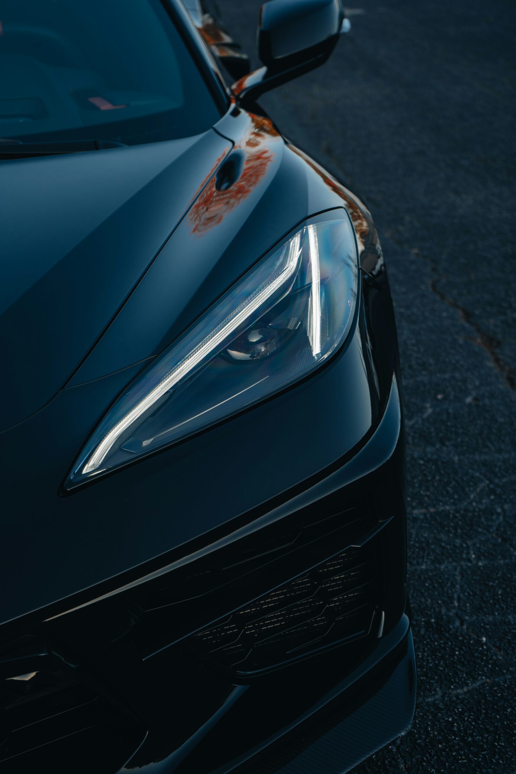 Nærbillede af forlygterne på en Tesla bil i skumringen